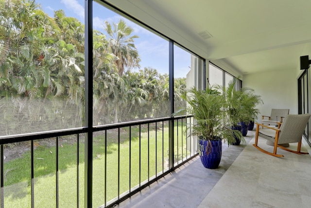 1700 Presidential Way Unit 201, West Palm Beach, FL 33401 - sunroom with floor to ceiling windows and concrete floors