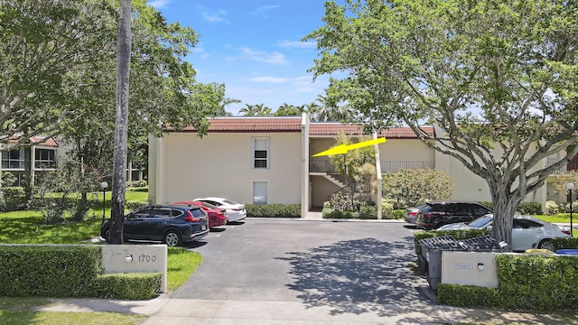 1700 Presidential Way Unit 201, West Palm Beach, FL 33401 - view of building exterior featuring uncovered parking