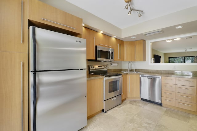 1700 Presidential Way Unit 201, West Palm Beach, FL 33401 - kitchen featuring appliances with stainless steel finishes, a sink, light brown cabinets, recessed lighting, and rail lighting