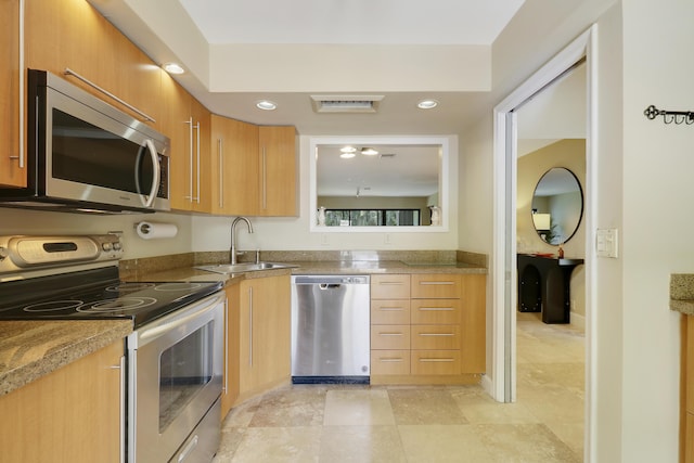 1700 Presidential Way Unit 201, West Palm Beach, FL 33401 - kitchen with appliances with stainless steel finishes, a sink, recessed lighting, and brown cabinetry