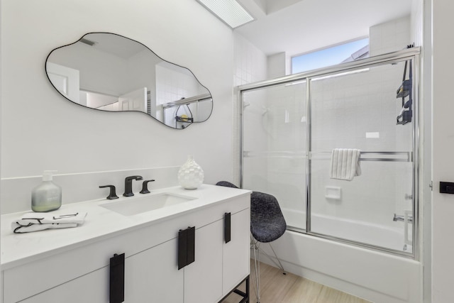 13853 Palm Grove Pl, West Palm Beach, FL 33418 - full bath with combined bath / shower with glass door, vanity, and wood finished floors