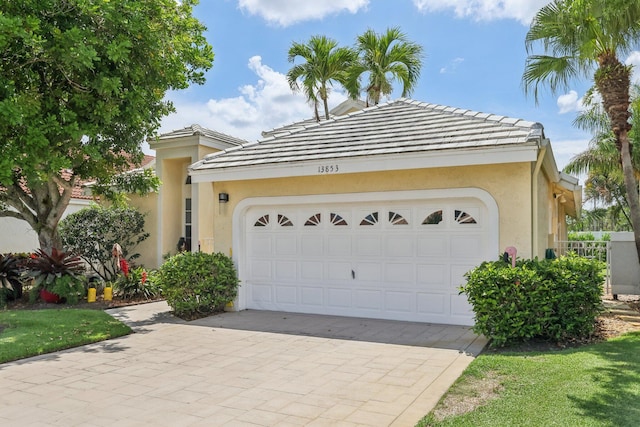 13853 Palm Grove Pl, West Palm Beach, FL 33418 - garage featuring decorative driveway