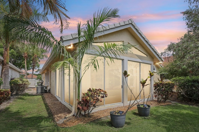 13853 Palm Grove Pl, West Palm Beach, FL 33418 - view of side of property featuring a yard, stucco siding, and cooling unit