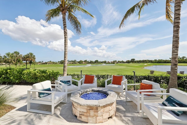 13853 Palm Grove Pl, West Palm Beach, FL 33418 - view of patio featuring view of golf course, a water view, and an outdoor living space with a fire pit