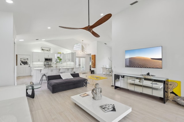 13853 Palm Grove Pl, West Palm Beach, FL 33418 - living area featuring recessed lighting, ceiling fan, light wood-style flooring, and high vaulted ceiling