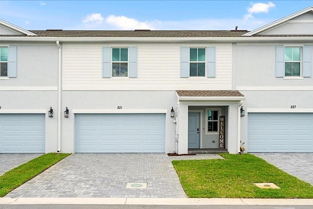 821 NE Trailside Run, Port Saint Lucie, FL 34983 - multi unit property featuring an attached garage, stucco siding, and decorative driveway