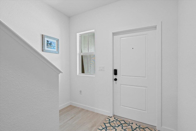 821 NE Trailside Run, Port Saint Lucie, FL 34983 - foyer entrance with baseboards and light wood-style floors