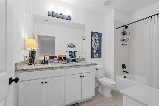 821 NE Trailside Run, Port Saint Lucie, FL 34983 - bathroom with toilet, double vanity, shower / bathtub combination with curtain, and a textured ceiling