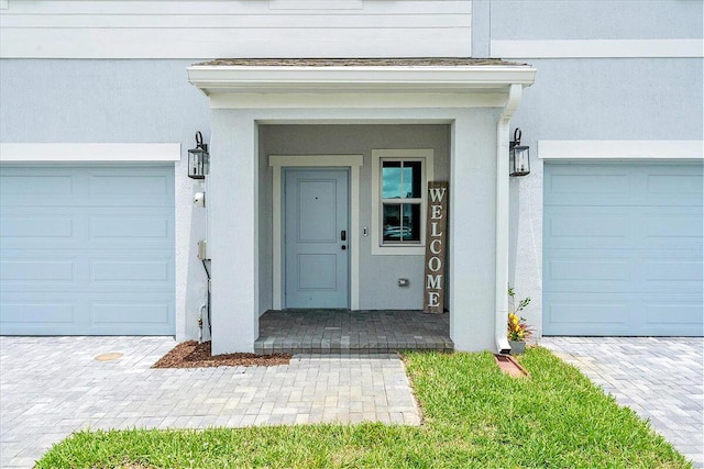 821 NE Trailside Run, Port Saint Lucie, FL 34983 - property entrance featuring a garage and stucco siding