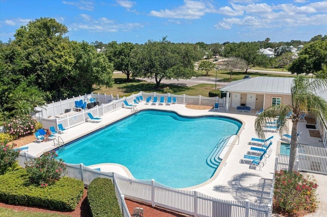 821 NE Trailside Run, Port Saint Lucie, FL 34983 - community pool with a patio area and view of wooded area