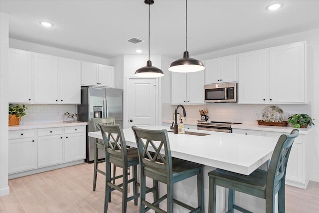 821 NE Trailside Run, Port Saint Lucie, FL 34983 - kitchen featuring stainless steel appliances, a sink, tasteful backsplash, white cabinetry, and recessed lighting