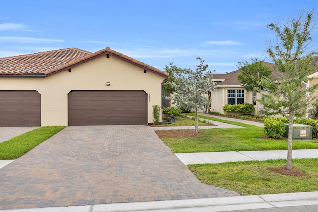 1246 Tangled Orchard Trce, Loxahatchee, FL 33470 - view of front facade featuring stucco siding, a front lawn, an attached garage, and driveway