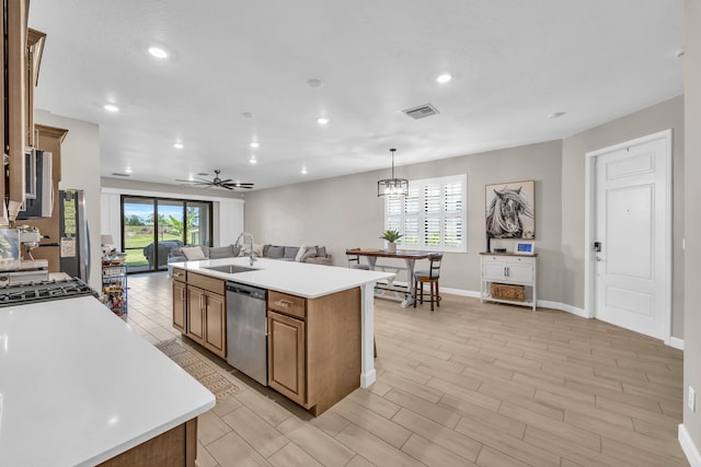 1246 Tangled Orchard Trce, Loxahatchee, FL 33470 - kitchen with dishwasher, a sink, open floor plan, recessed lighting, and light countertops