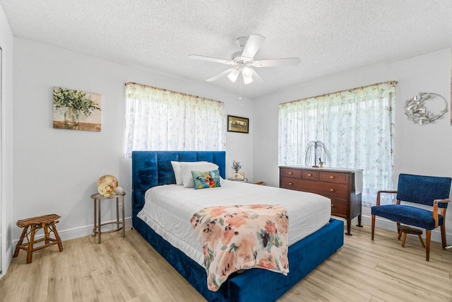 4260 Mango Tree Ct Unit B, Boynton Beach, FL 33436 - bedroom featuring wood finished floors, multiple windows, a textured ceiling, and baseboards