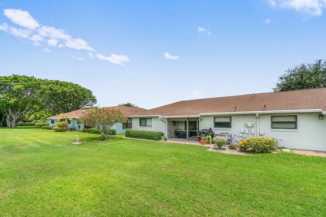 4260 Mango Tree Ct Unit B, Boynton Beach, FL 33436 - rear view of house featuring a yard, stucco siding, central air condition unit, and a sunroom
