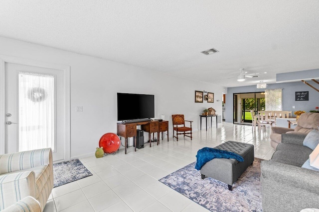 4260 Mango Tree Ct Unit B, Boynton Beach, FL 33436 - living area with a ceiling fan, a textured ceiling, light tile patterned floors, and baseboards
