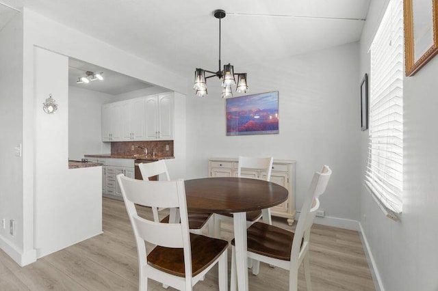 4051 Guildford C Unit 4051, Boca Raton, FL 33434 - dining area featuring light wood-type flooring, a chandelier, and baseboards