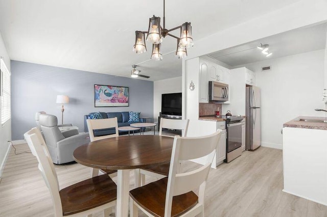 4051 Guildford C Unit 4051, Boca Raton, FL 33434 - dining area featuring light wood-type flooring, baseboards, and a chandelier