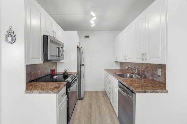 4051 Guildford C Unit 4051, Boca Raton, FL 33434 - kitchen with appliances with stainless steel finishes, a sink, backsplash, and white cabinets