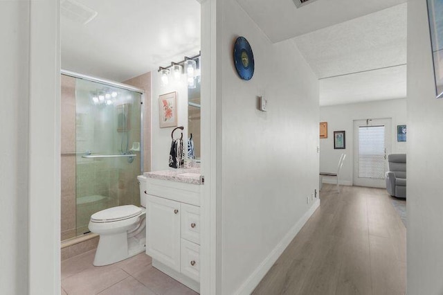 4051 Guildford C Unit 4051, Boca Raton, FL 33434 - bathroom featuring vanity, a shower stall, toilet, and tile patterned floors