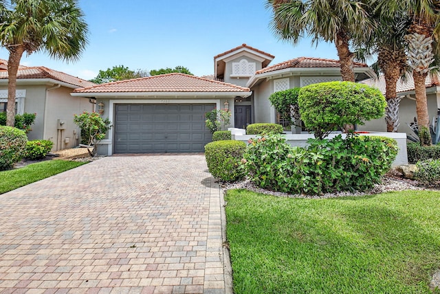 7030 Boscanni Dr Unit 7030, Boynton Beach, FL 33437 - mediterranean / spanish-style home featuring decorative driveway, an attached garage, stucco siding, and a tiled roof
