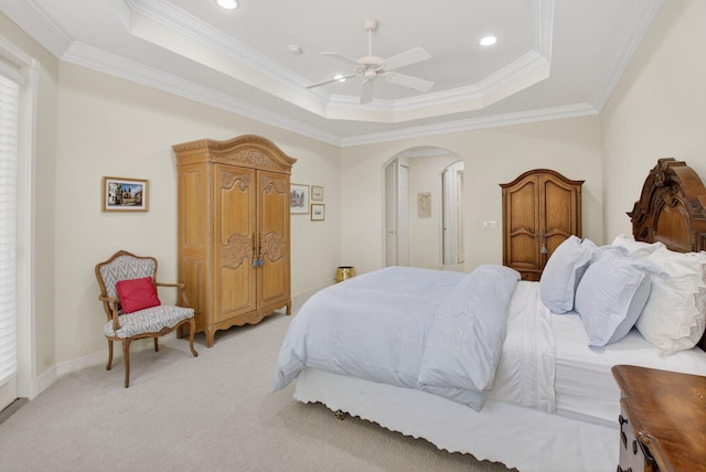 7030 Boscanni Dr Unit 7030, Boynton Beach, FL 33437 - bedroom featuring a tray ceiling, arched walkways, light colored carpet, ornamental molding, and ceiling fan
