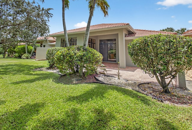 7030 Boscanni Dr Unit 7030, Boynton Beach, FL 33437 - back of property with stucco siding, a tiled roof, a lawn, and a patio area