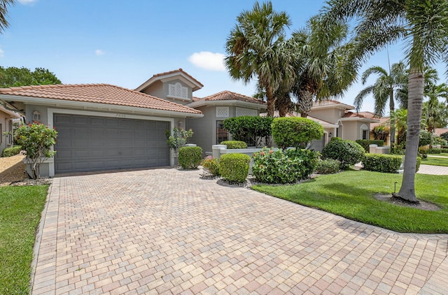 7030 Boscanni Dr Unit 7030, Boynton Beach, FL 33437 - mediterranean / spanish-style house with an attached garage, stucco siding, a front lawn, decorative driveway, and a tiled roof