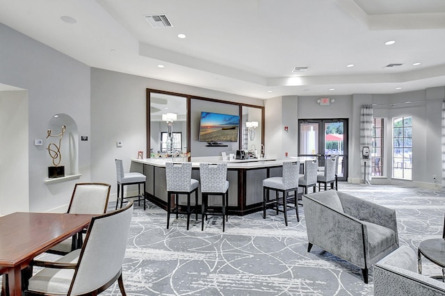 7030 Boscanni Dr Unit 7030, Boynton Beach, FL 33437 - living area featuring a raised ceiling, recessed lighting, wet bar, baseboards, and light colored carpet