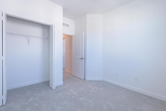 242 SE Woodbark St, Port Saint Lucie, FL 34984 - unfurnished bedroom with light colored carpet, a closet, and baseboards