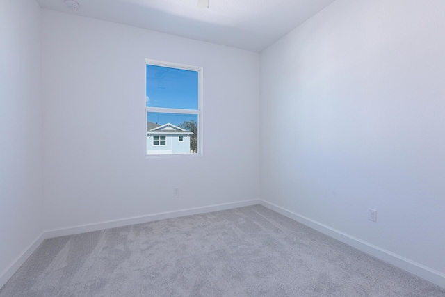 242 SE Woodbark St, Port Saint Lucie, FL 34984 - carpeted empty room featuring baseboards