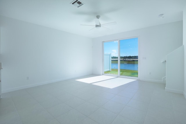 242 SE Woodbark St, Port Saint Lucie, FL 34984 - spare room featuring ceiling fan, a water view, and baseboards