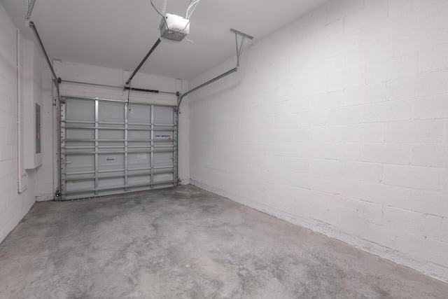 242 SE Woodbark St, Port Saint Lucie, FL 34984 - garage featuring a garage door opener and concrete block wall
