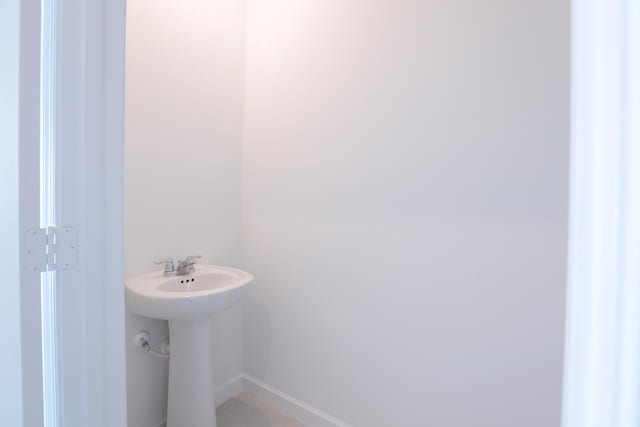 242 SE Woodbark St, Port Saint Lucie, FL 34984 - bathroom with baseboards and a sink