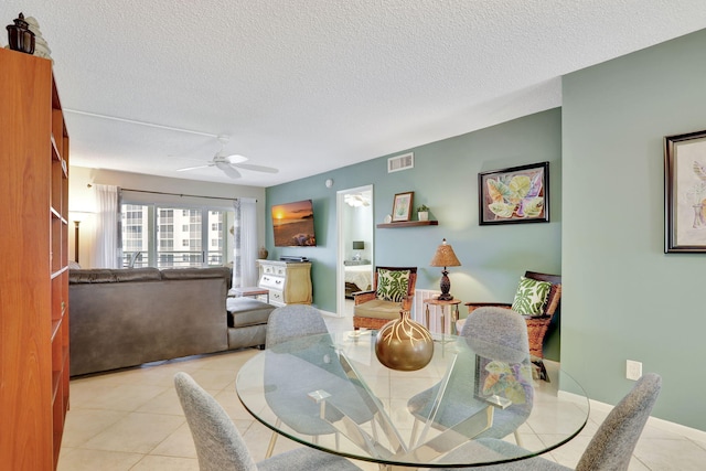 2731 NE 14th Cswy Unit 702, Pompano Beach, FL 33062 - tiled dining space featuring a ceiling fan and a textured ceiling