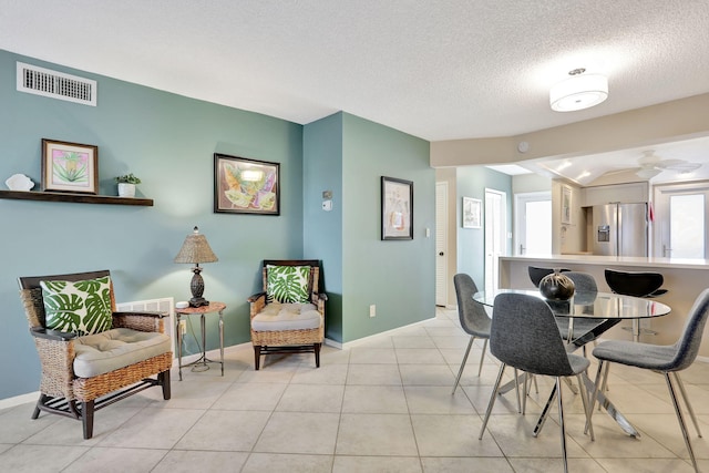2731 NE 14th Cswy Unit 702, Pompano Beach, FL 33062 - dining area with baseboards, a textured ceiling, light tile patterned floors, and a ceiling fan