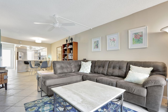 2731 NE 14th Cswy Unit 702, Pompano Beach, FL 33062 - living room with ceiling fan, healthy amount of natural light, light tile patterned floors, and a textured ceiling