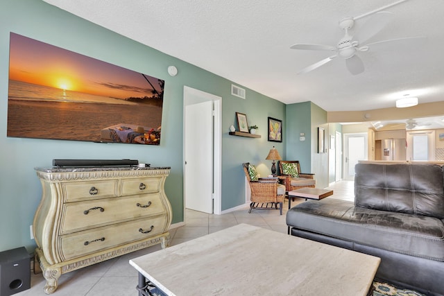 2731 NE 14th Cswy Unit 702, Pompano Beach, FL 33062 - living area featuring a ceiling fan, light tile patterned floors, a textured ceiling, and baseboards