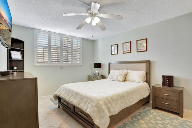 2731 NE 14th Cswy Unit 702, Pompano Beach, FL 33062 - bedroom featuring a textured ceiling, baseboards, light tile patterned flooring, and a ceiling fan
