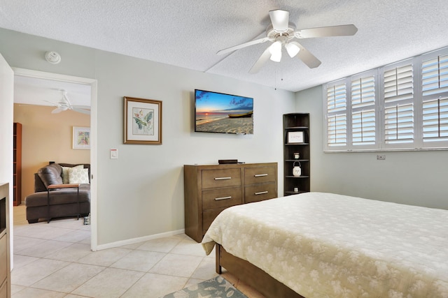 2731 NE 14th Cswy Unit 702, Pompano Beach, FL 33062 - bedroom featuring a textured ceiling, light tile patterned flooring, a ceiling fan, and baseboards
