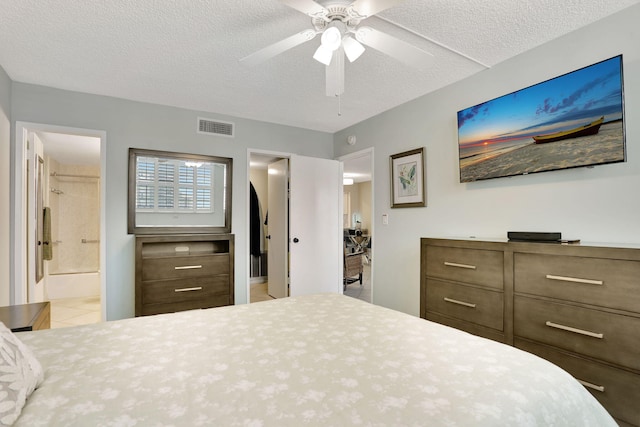 2731 NE 14th Cswy Unit 702, Pompano Beach, FL 33062 - tiled bedroom with a textured ceiling, ensuite bathroom, and ceiling fan