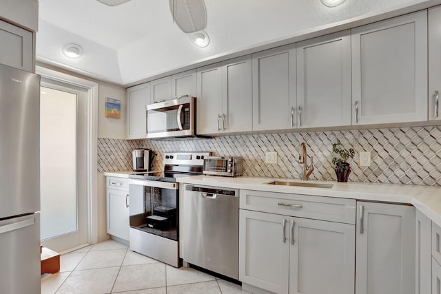 2731 NE 14th Cswy Unit 702, Pompano Beach, FL 33062 - kitchen featuring stainless steel appliances, a sink, gray cabinetry, and light countertops