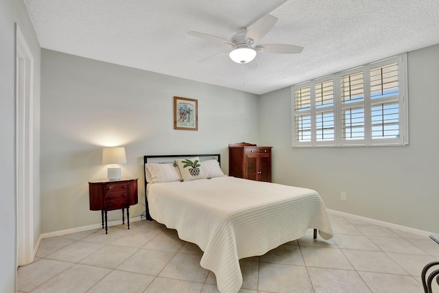 2731 NE 14th Cswy Unit 702, Pompano Beach, FL 33062 - bedroom featuring light tile patterned flooring, a textured ceiling, baseboards, and a ceiling fan