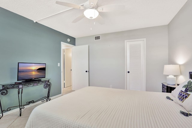 2731 NE 14th Cswy Unit 702, Pompano Beach, FL 33062 - bedroom with light tile patterned floors, a closet, a textured ceiling, and a ceiling fan