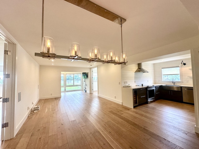 3 Colonial Club Dr Unit 104, Boynton Beach, FL 33435 - kitchen with a sink, light countertops, appliances with stainless steel finishes, wall chimney exhaust hood, and light wood-style flooring