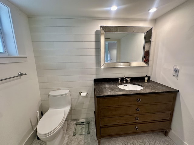 3 Colonial Club Dr Unit 104, Boynton Beach, FL 33435 - bathroom featuring vanity, toilet, tile patterned flooring, and baseboards