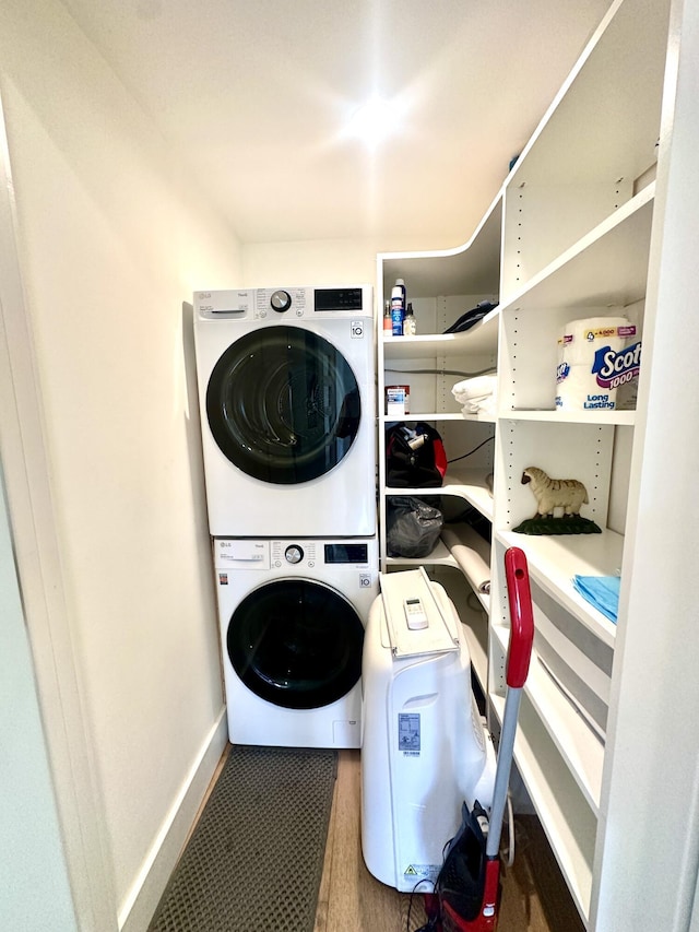 3 Colonial Club Dr Unit 104, Boynton Beach, FL 33435 - laundry room featuring stacked washing machine and dryer and baseboards