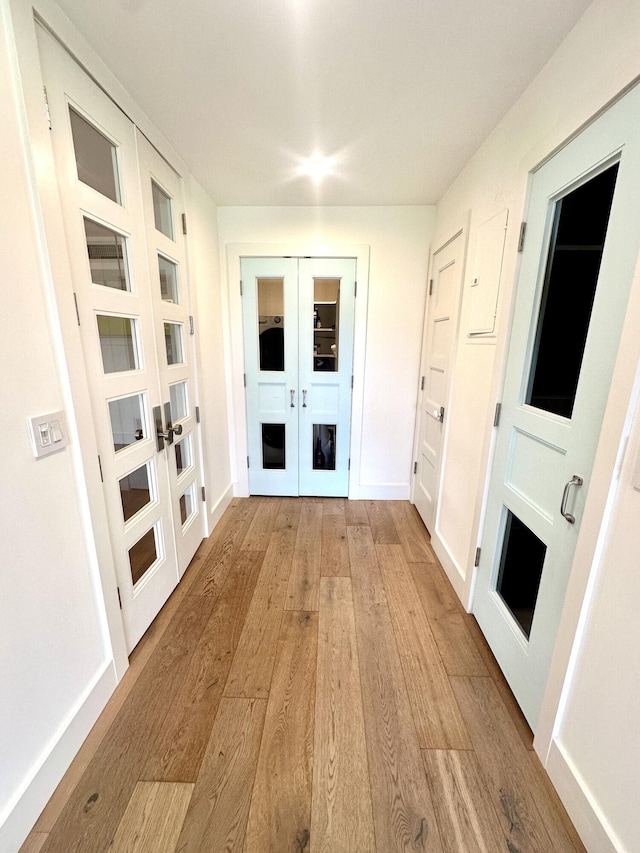 3 Colonial Club Dr Unit 104, Boynton Beach, FL 33435 - hallway featuring french doors, light wood-type flooring, and baseboards
