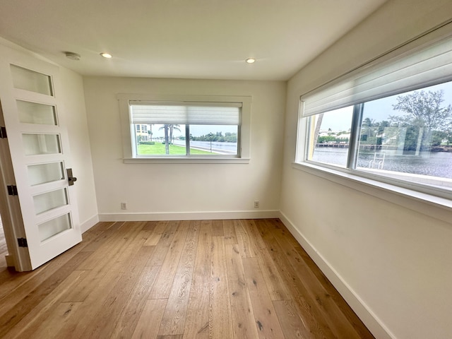 3 Colonial Club Dr Unit 104, Boynton Beach, FL 33435 - empty room with hardwood / wood-style flooring, healthy amount of natural light, a water view, baseboards, and recessed lighting