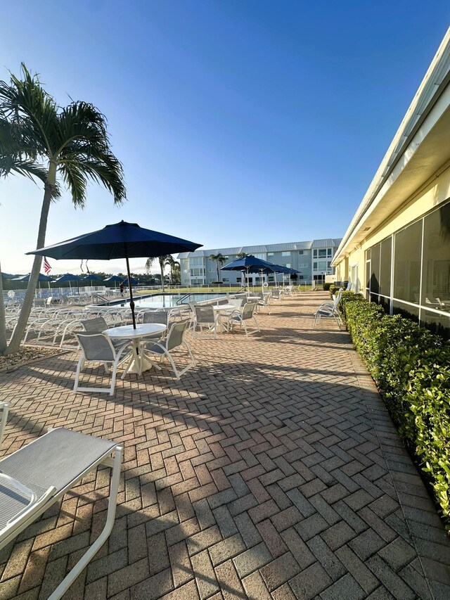 3 Colonial Club Dr Unit 104, Boynton Beach, FL 33435 - surrounding community featuring a patio area